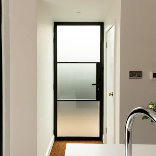 Aluco black steel look aluminium back door with obscured glass.