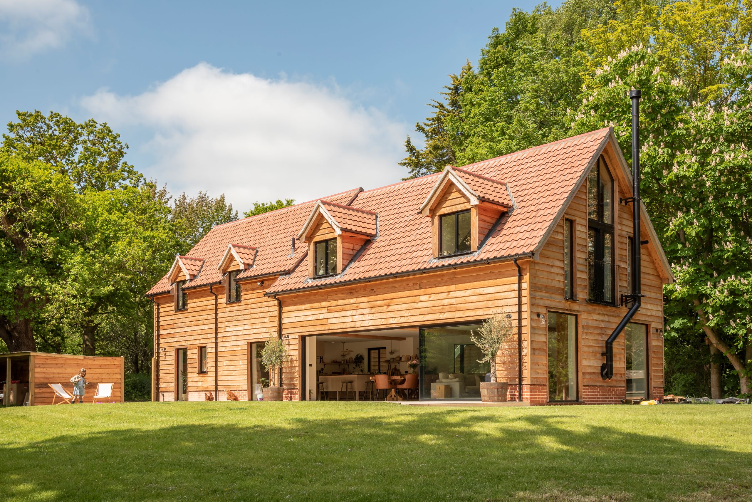 Ultra slim sliding doors frame a beautiful garden for Suffolk family