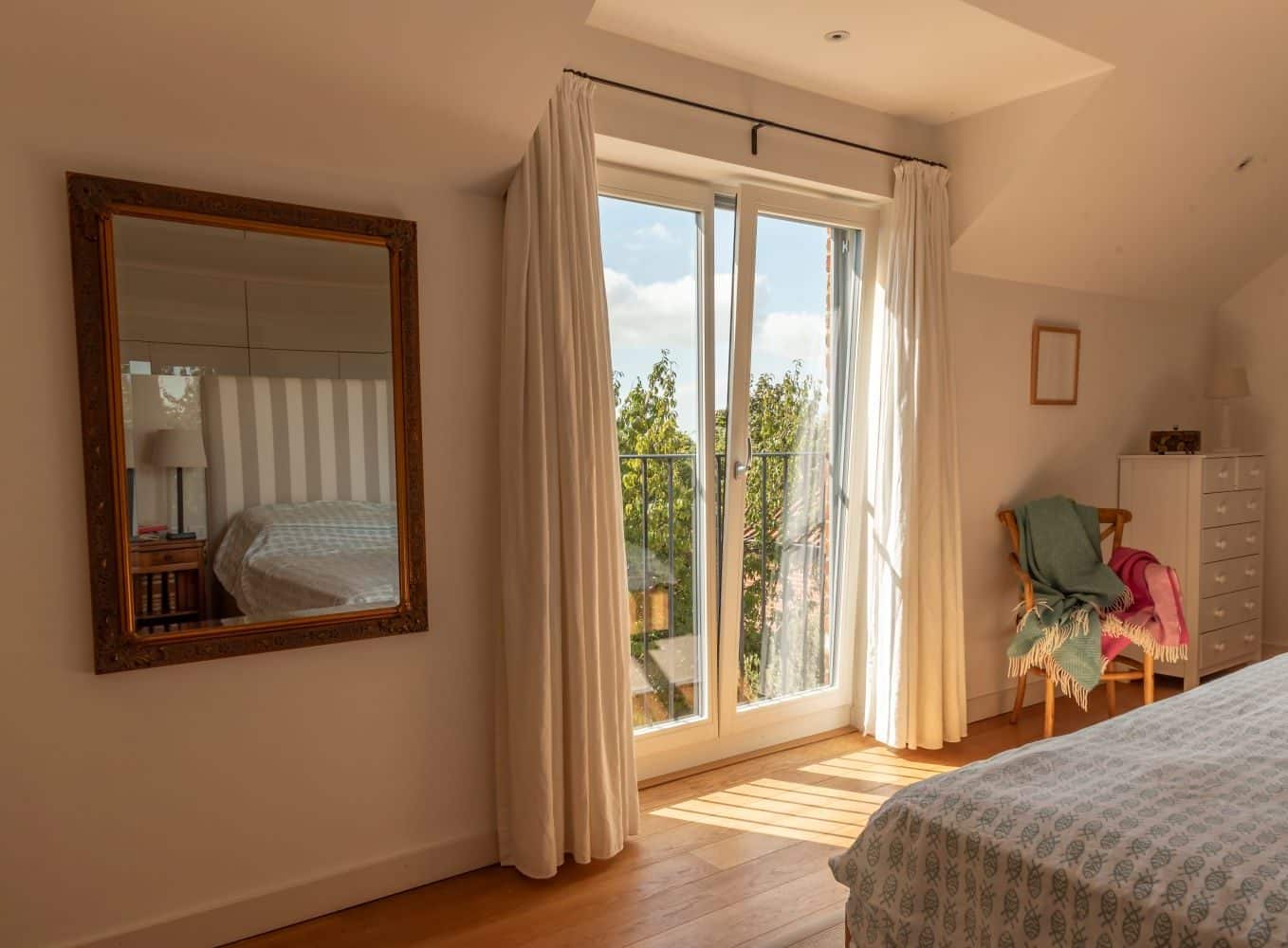 Timber French windows in Window Grey on the outside and pure white on the inside, with tilt and turn feature to allow a small fixed opening for ventilation.