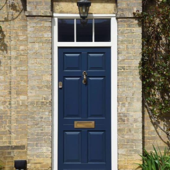 Chadlington timber entrance door in Harewood grey with Samuel Heath Antique brass unlacquered doctors door knocker