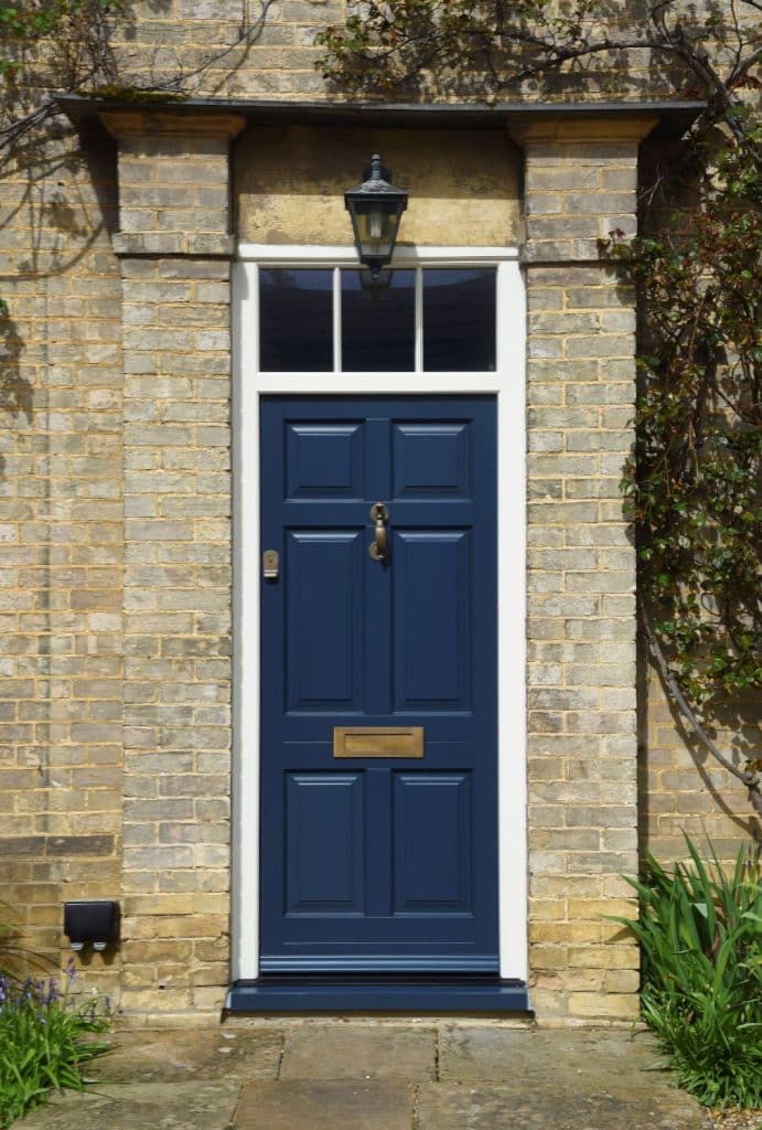 Chadlington timber entrance door in Harewood grey with Samuel Heath Antique brass unlacquered doctors door knocker
