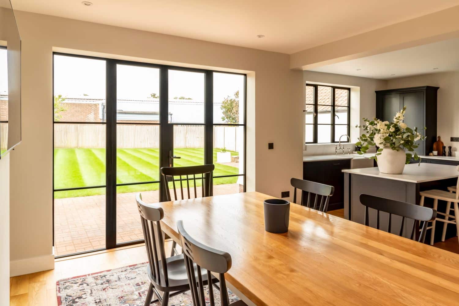 Steel look aluminium French doors and windows in black with astragal bars