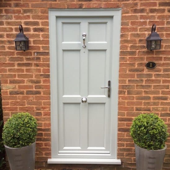 Evolution PVCu Timber Effect traditional entrance door with doctors door knocker
