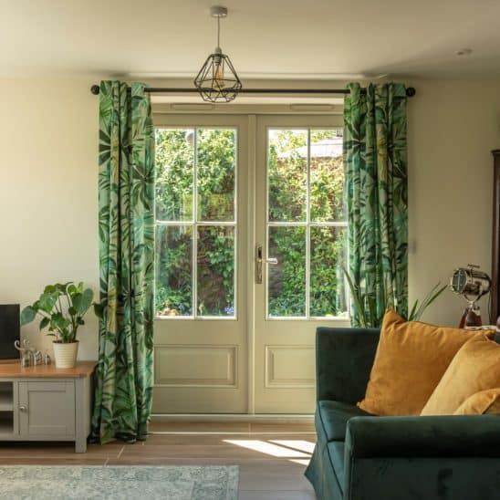 'Bardwell' timber French doors in French Grey with 18mm glazing bars and a raised and fielded door panel. Newbury polished nickel lever handle.