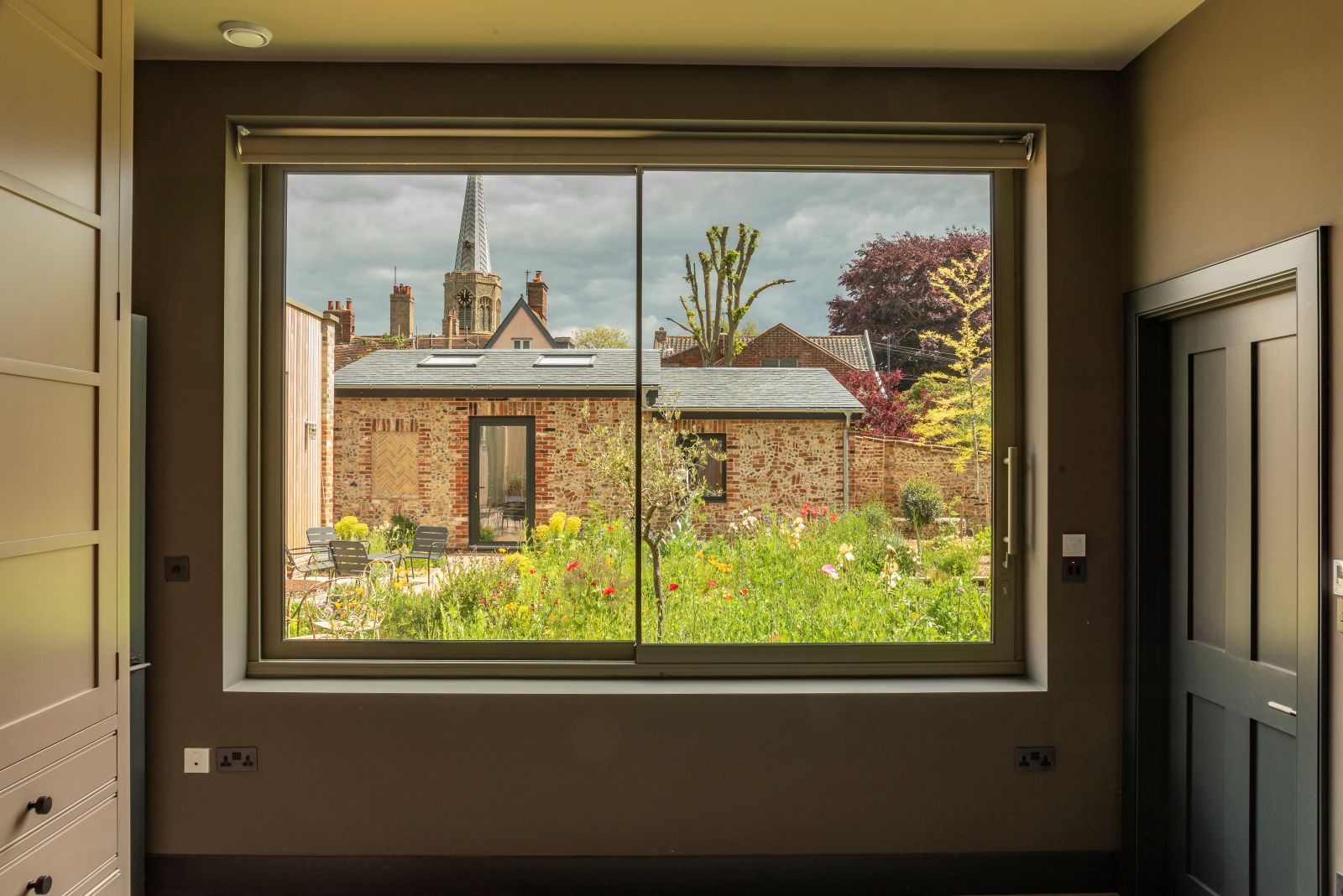 Sunflex aluminium SVG20 sliding windows with ultra slim 20mm sightlines and stainless steel bar handle, in Olive Grey