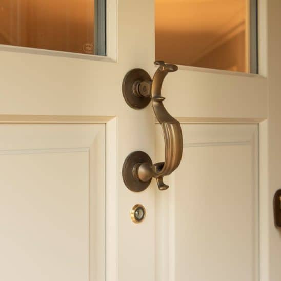 Polished brass doctors door knocker on Timber Chalfont door