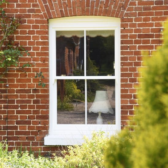 Slim 142mm timber sash window with 18mm astragal bar in off white
