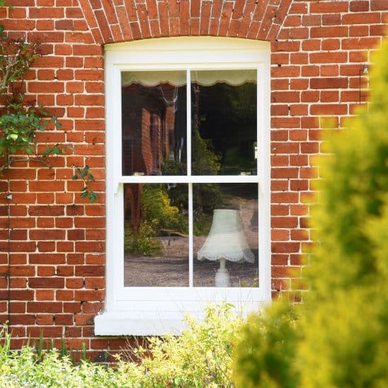 Slim wooden sash window with 18mm astragal bar in off white
