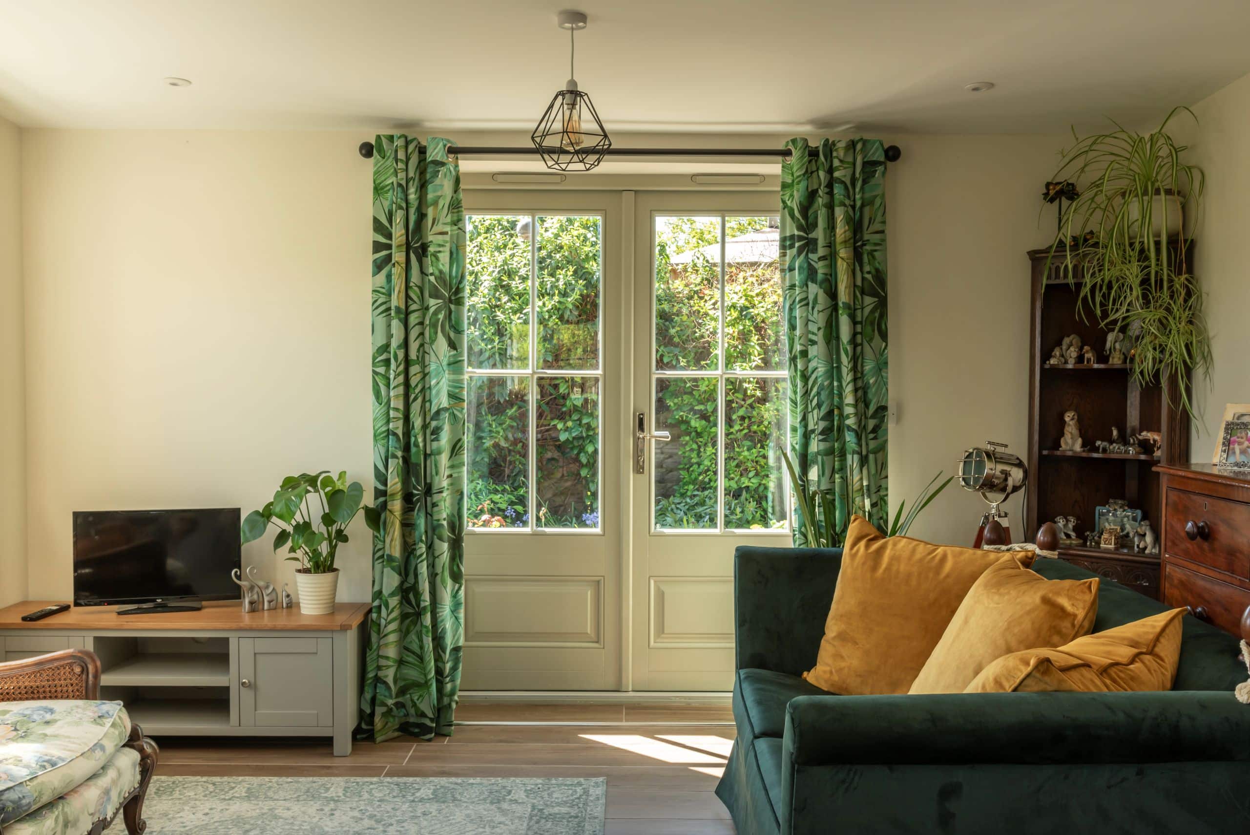 Wooden Bardwell French doors in Pebble Grey with 18mm astragal bars and a Newbury polished nickel handle