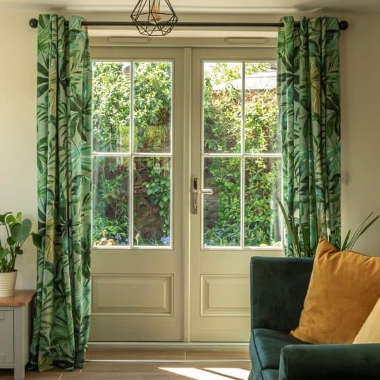 Wooden Bardwell French doors in Pebble Grey with 18mm glazing bars and a Newbury polished nickel handle