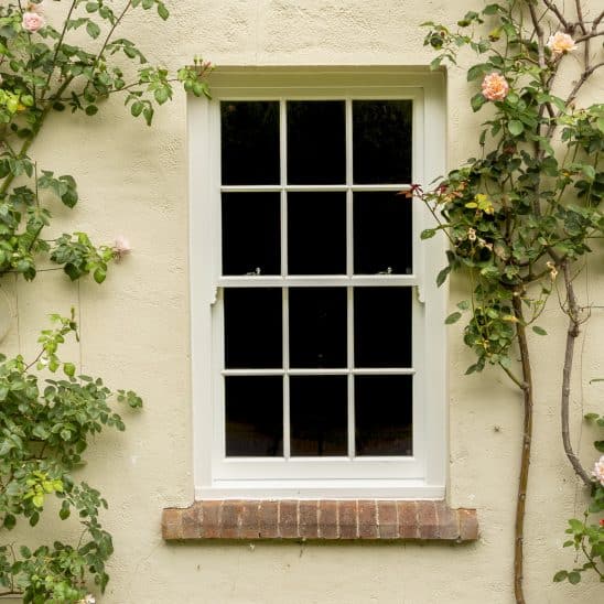 Slim timber sash windows with 18mm astragal bars in white
