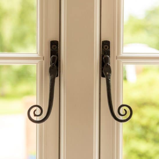 Evolution flush-fitting window with black wrought iron monkey tail handle
