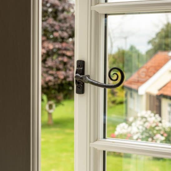 Evolution flush-fitting window with black wrought iron monkey tail handle