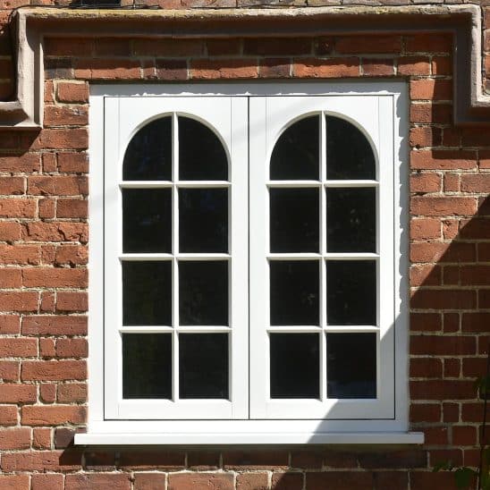 Timber cottage casement window with arched swept heads and 18mm glazing bars in white