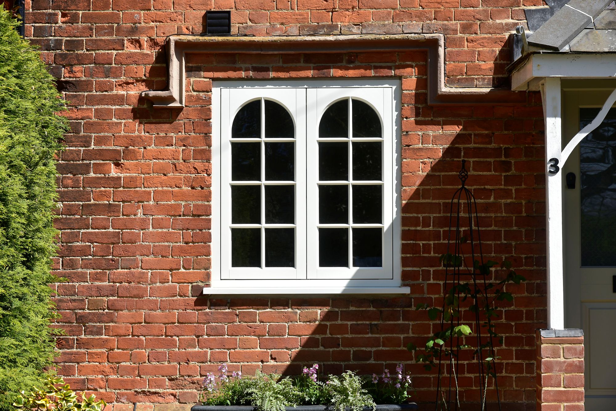 Timber cottage casement window with arched swept heads and 18mm glazing bars