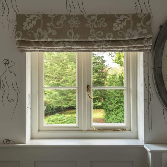 Flush timber cottage casement window in Wimborne White with polished brass lacquered peardrop handles and pegstay.
