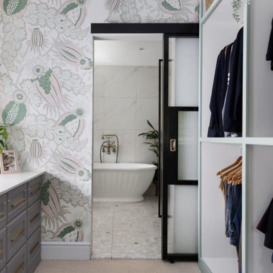 Aluco internal sliding door with steel look glazing bars, reeded glass and antique brass sliding door handle