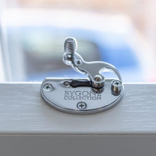 Bygone PVCu sash window latch with beehive design in polished chrome
