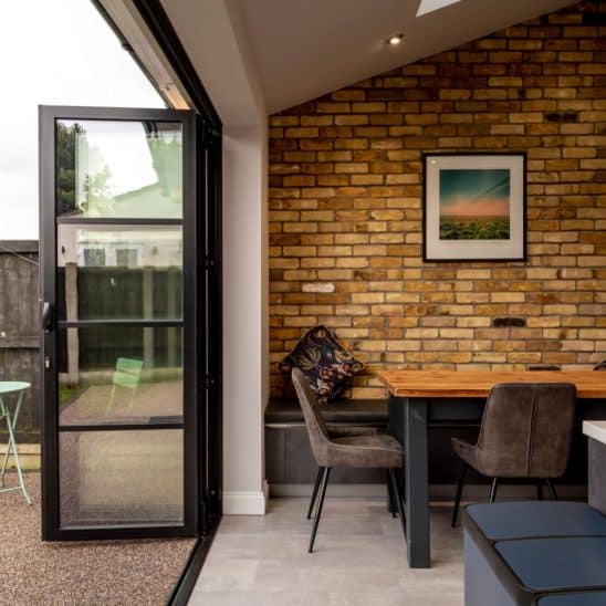 Slim stacking Sunflex bifold doors in graphite black with 30mm heritage style bars