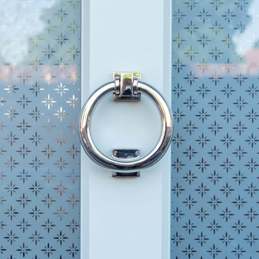 Timber Kingston front door in French Grey with off-white frame, etched star glass and 316 Coastal stainless steel ring knocker. letterbox and handle