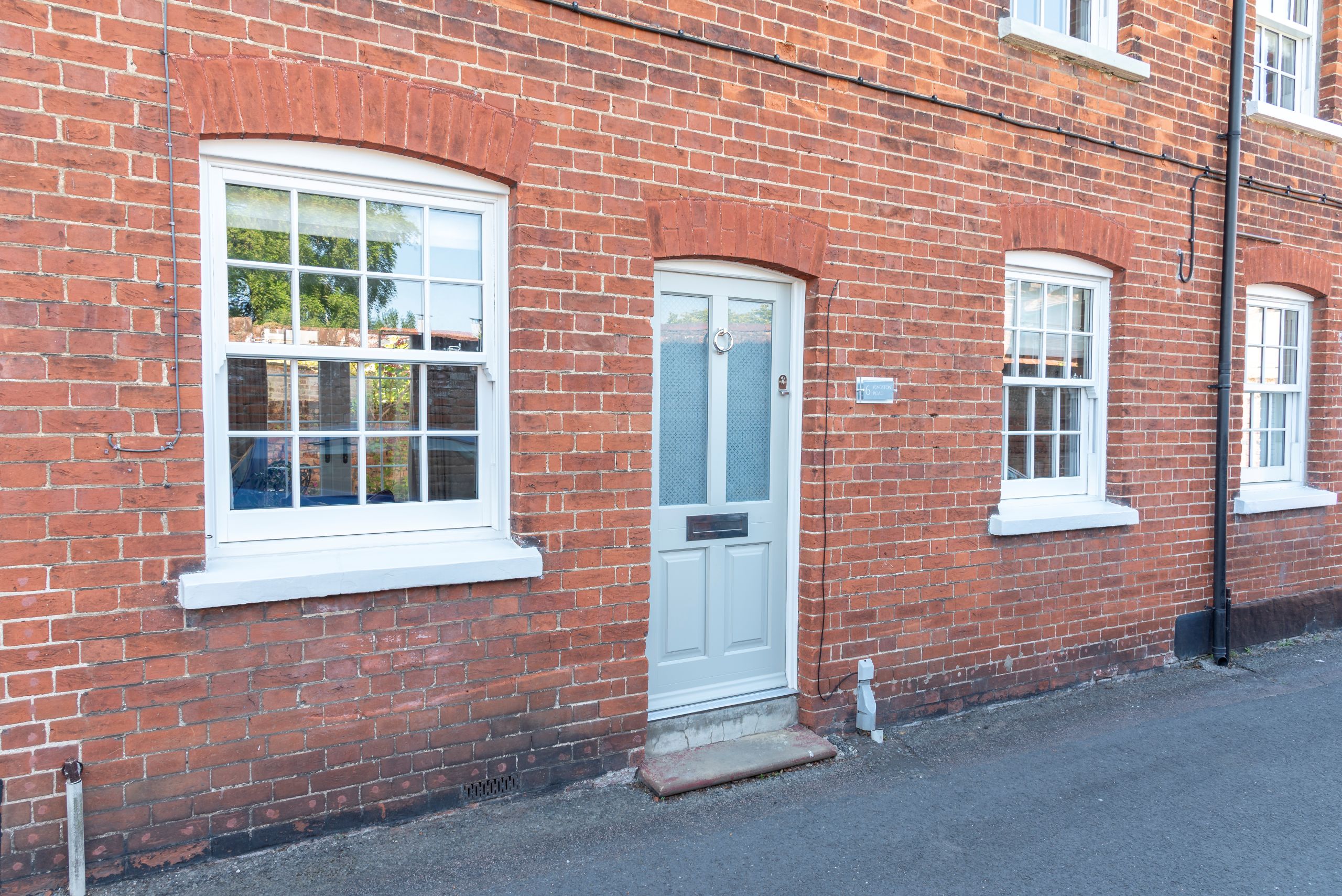 Timber Kingston front door with etched star glass, and Bygone timber alternative sash window