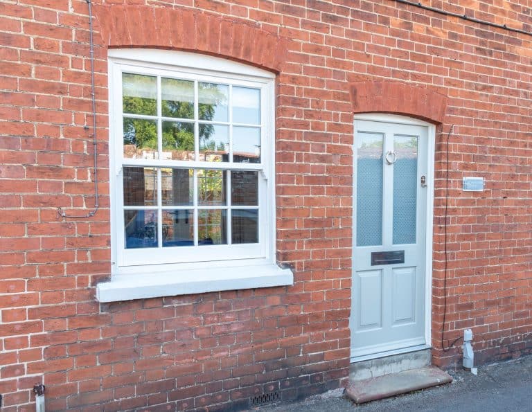 Timber Kingston front door with etched star glass, and Bygone timber alternagove sash window