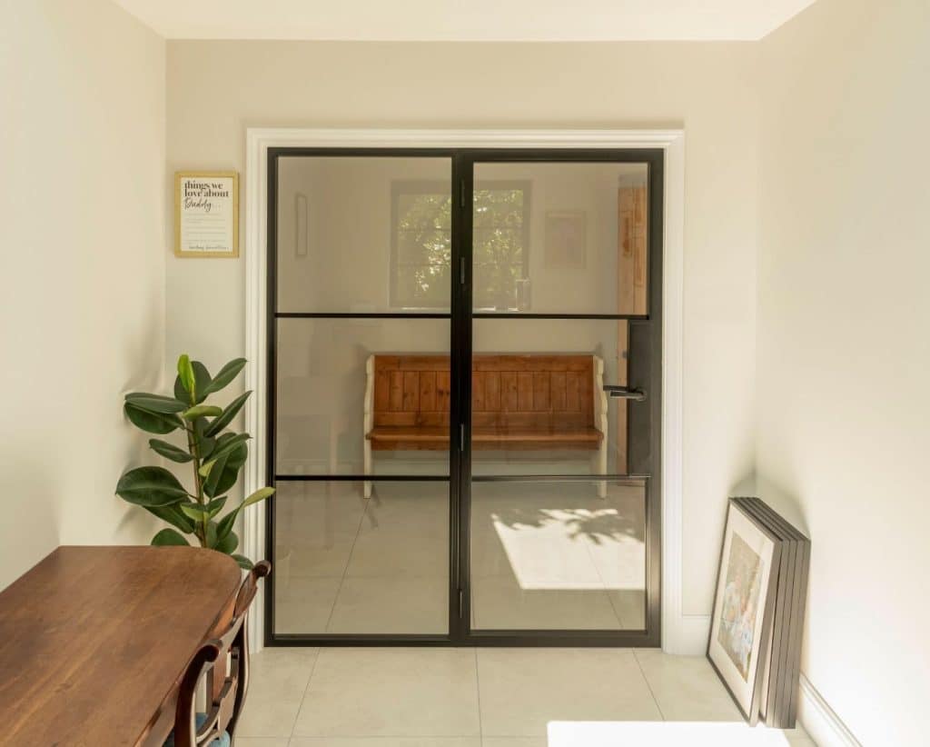 Aluco aluminium steel look internal glazed door with side panel, super slim 20mm glazing bars and Leon handle in matt Black