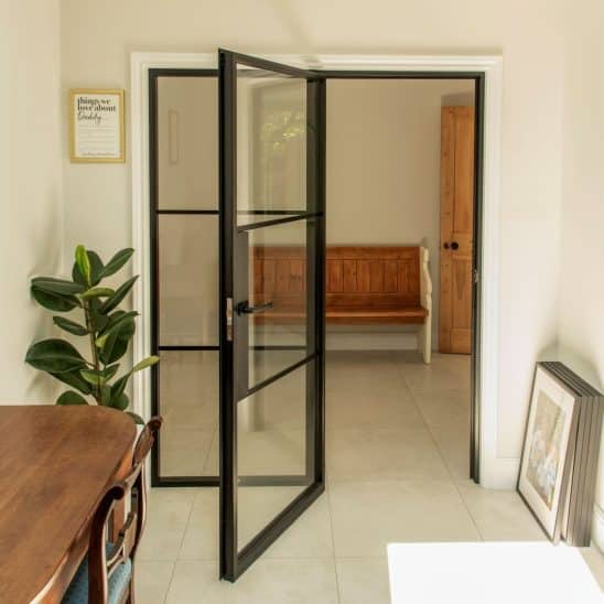 Aluco aluminium steel look internal glazed door with side panel, super slim 20mm glazing bars and Leon handle in matt Black