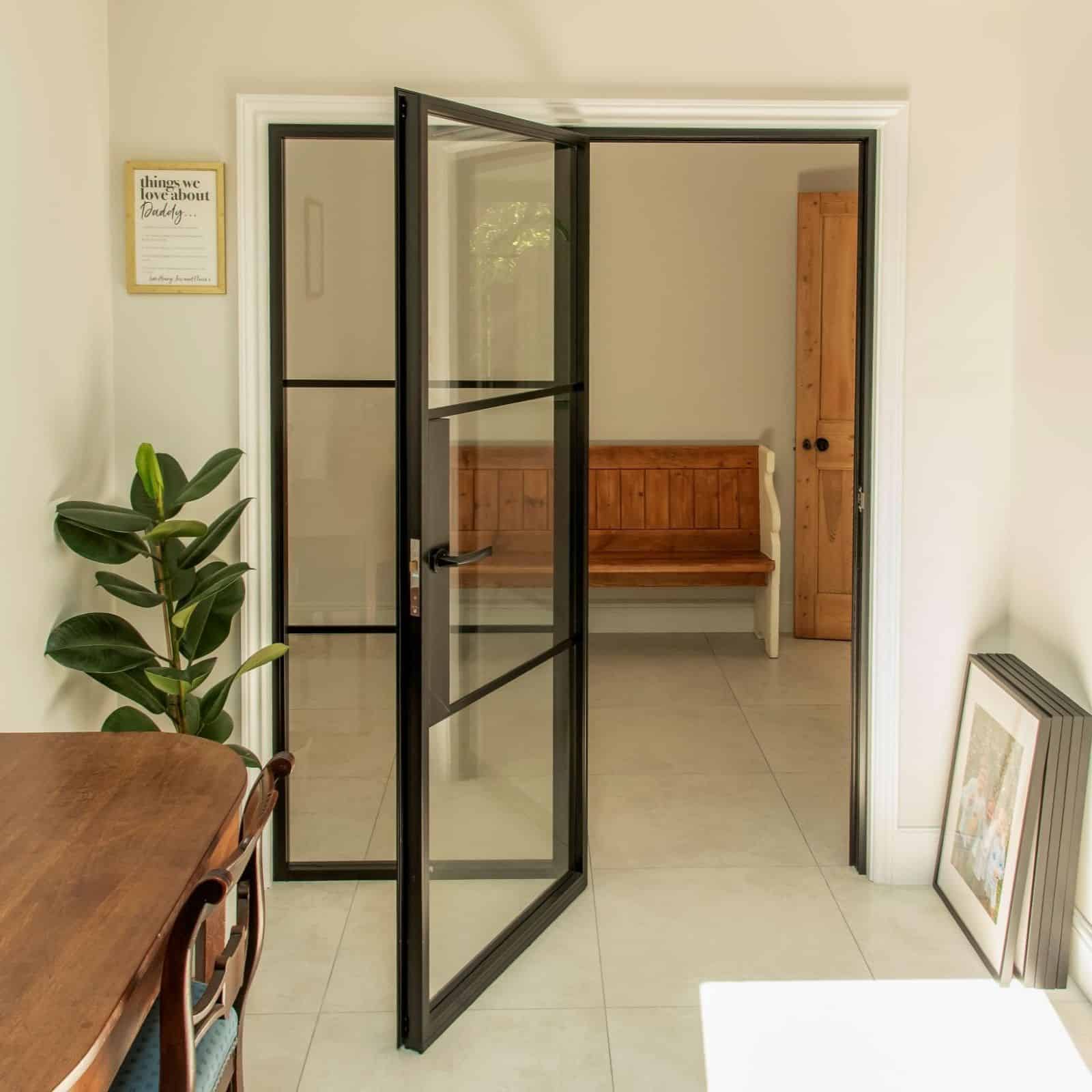 Aluco aluminium steel look internal glazed door with side panel, super slim 20mm glazing bars and Leon handle in matt Black