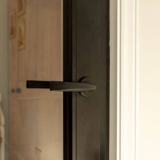 Aluco aluminium steel look internal glazed door with side panel, super slim 20mm glazing bars and Leon handle in matt Black