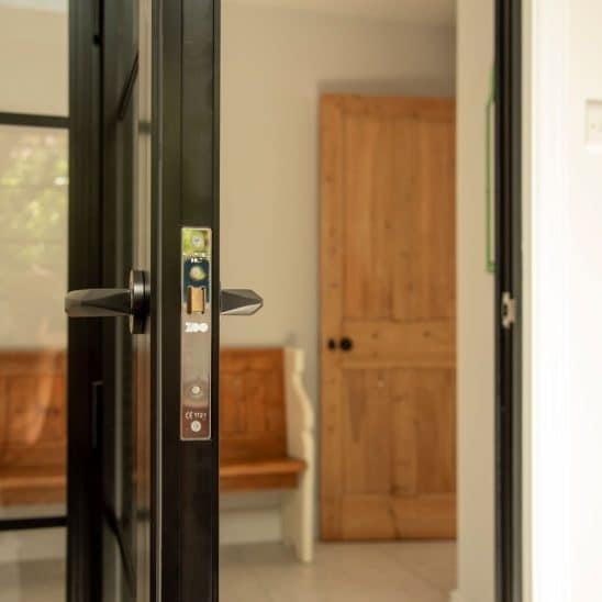 Aluco aluminium steel look internal glazed door with side panel, super slim 20mm glazing bars and Leon handle in matt Black