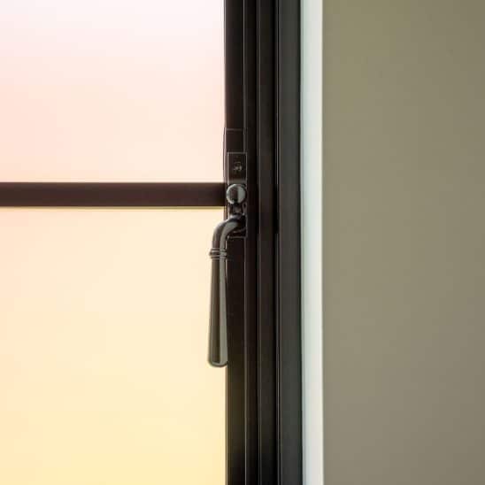 Aluco aluminium steel look window with super slim glazing bars in matt Black with Newbury handle and sandblasted obscured glass