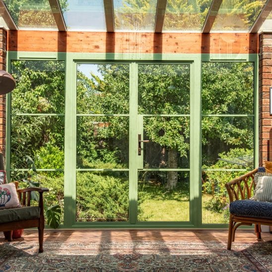 Green Aluco steel look French doors with side lights and super slim 20mm glazing bars.