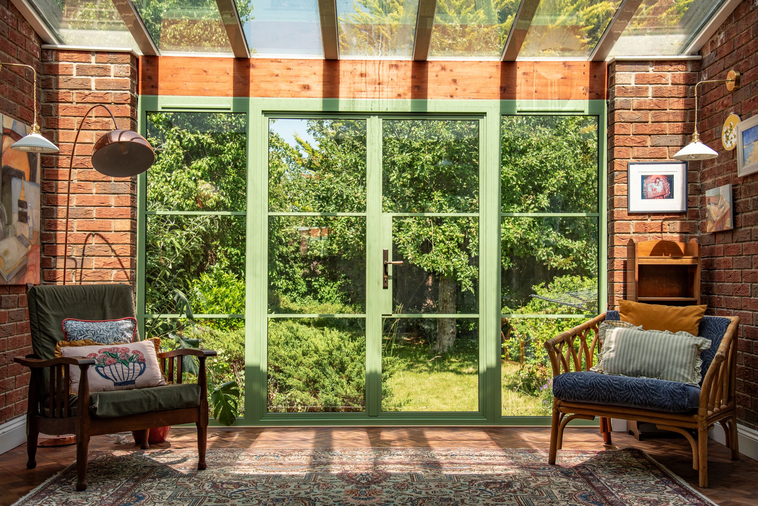 Green Aluco steel look French doors with side lights and super slim 20mm glazing bars.