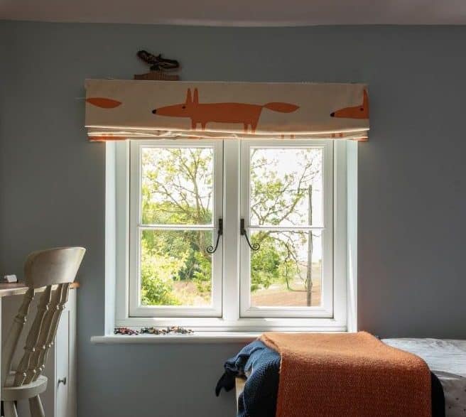 Evolution PVCu flush casement window with a single horizontal Georgian bar and black monkeytail handles. Olive Grey on the outside, white on the inside.
