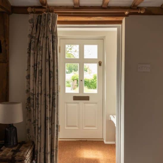 Engineered timber front 'Frenchay' townhouse door with Samuel Heath antique brass unlacquered escutcheon, door knob and letterbox, in Off White on the inside and French Grey on the outside.