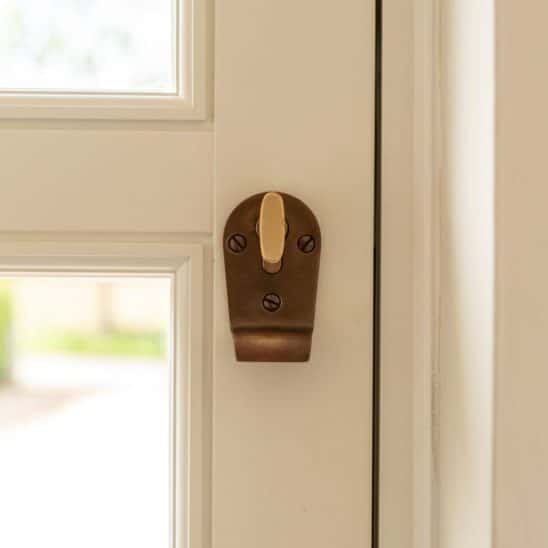 Engineered timber front 'Frenchay' townhouse door with Samuel Heath antique brass unlacquered escutcheon with thumbturn on the inside. Colour - Off White on the inside and French Grey on the outside.