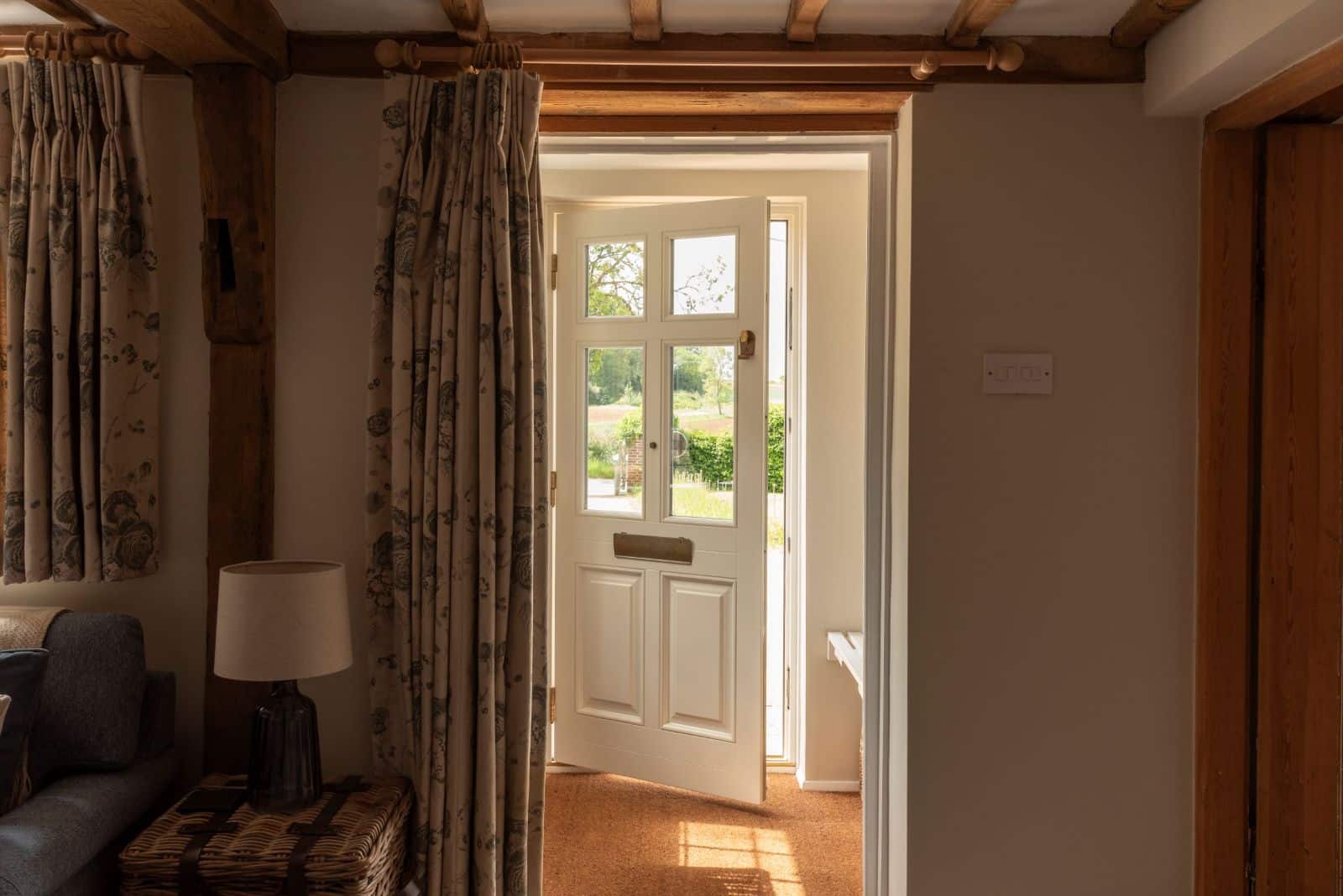 Engineered timber front 'Frenchay' townhouse door with Samuel Heath antique brass unlacquered escutcheon, door knob and letterbox, in Off White on the inside and French Grey on the outside.