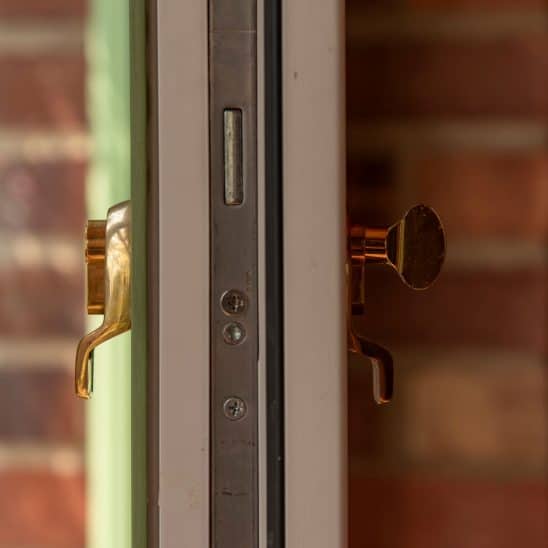 Evolution Ballingdon PVCu entrance door with brass escutcheon, internal thumb turn and integrated locking for advanced security