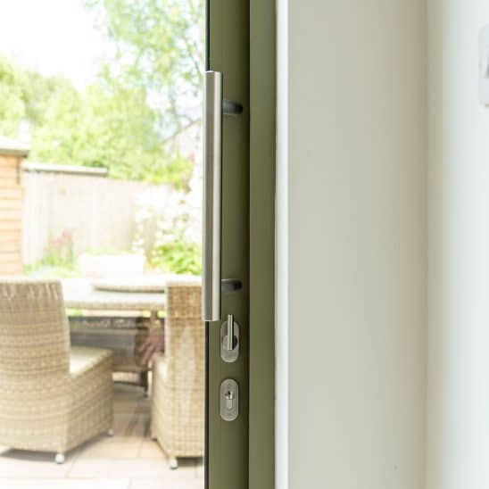 Sunflex SVG30 sliding doors in green with stainless steel bar handle and lock