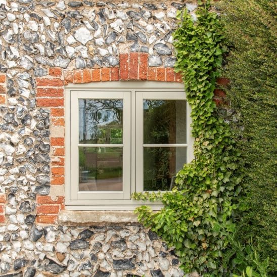Evolution PVCu flush casement window with a single horizontal Georgian bar in Olive Grey