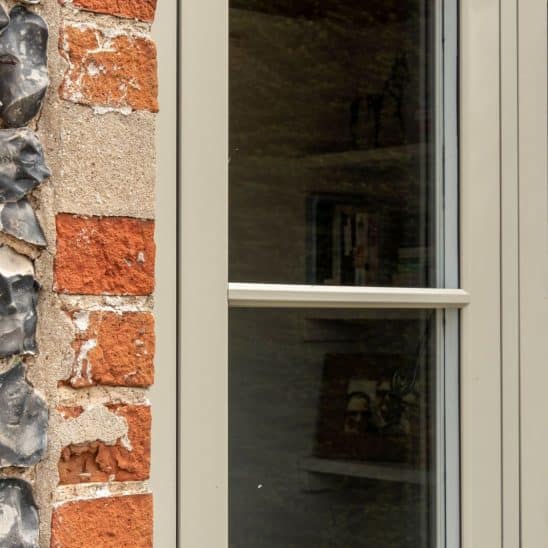 Evolution PVCu flush casement window with a single, timber look horizontal Georgian bar in Olive Grey
