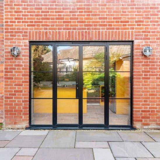 Black heritage, Art Deco aluminium patio doors with floating lock detail, slim glazing bars and side panels