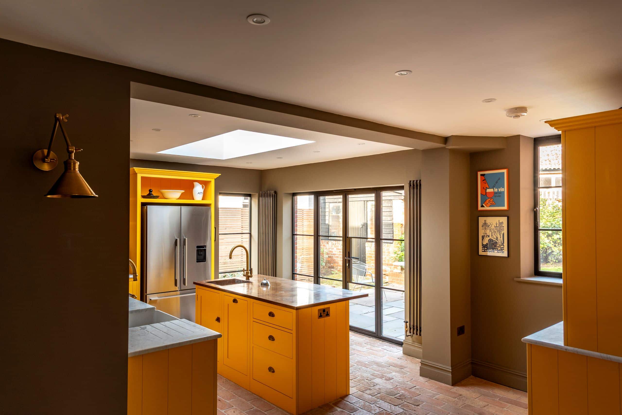 Contemporary kitchen with black aluminium heritage glazing and Patio doors featuring ultra slim glazing bars in Orford home