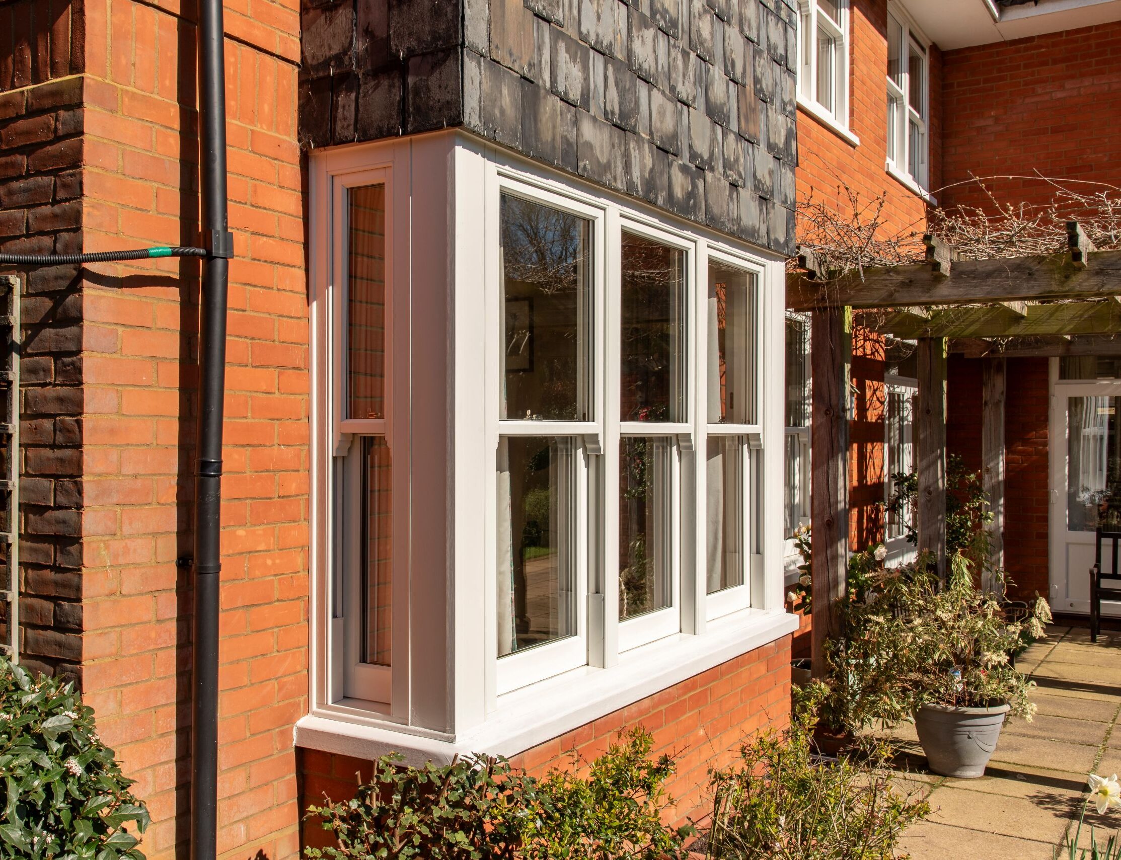 Bygone PVCu sash windows create a beautifully elegant bay for this Woodbridge home