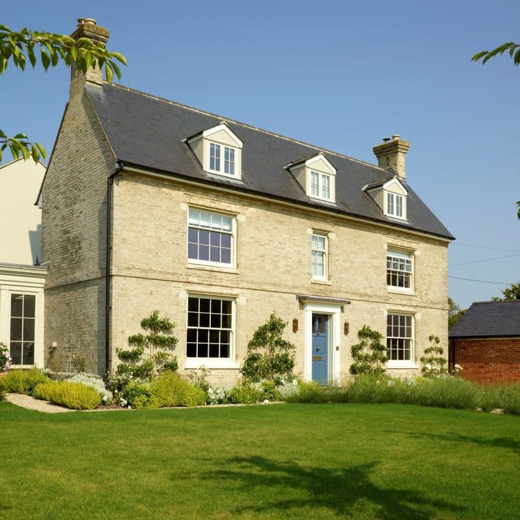 Slim timber sash windows in Farrow & Ball Slipper Satin and Chalfont timber entrance door in Farrow & Ball Stiffkey Blue