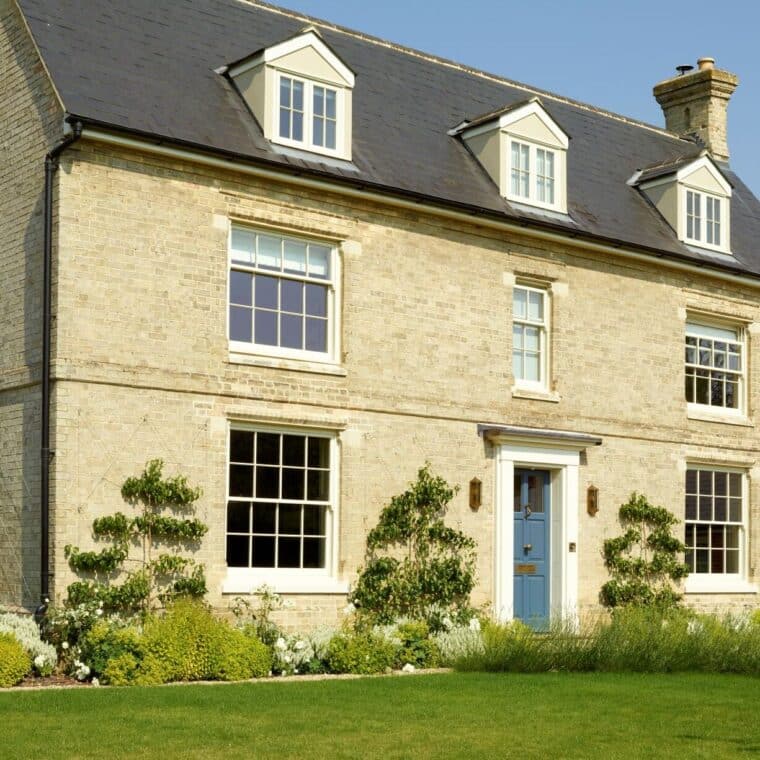 Slim timber sash windows in Farrow & Ball Slipper Satin and Chalfont timber entrance door in Farrow & Ball Stiffkey Blue