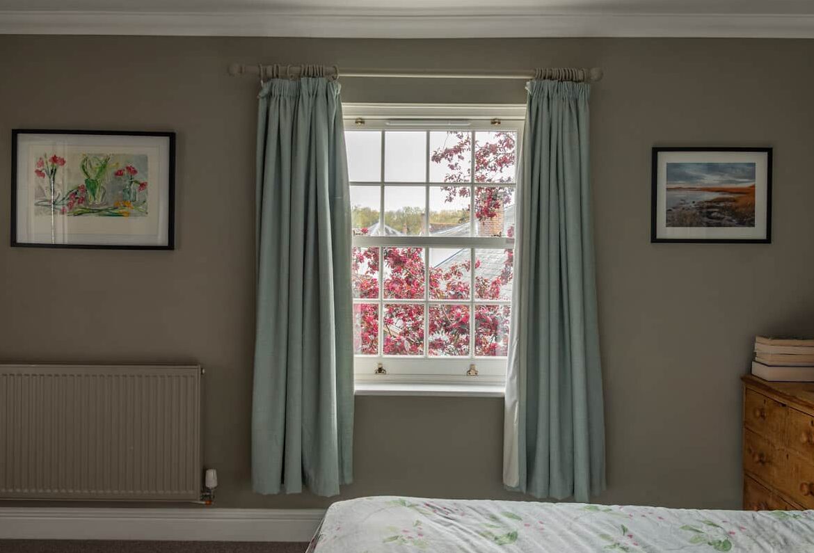 Bygone PVCu sash windows. Elegantly slim glazing bars and mid rail maximise your view and fill your room with light