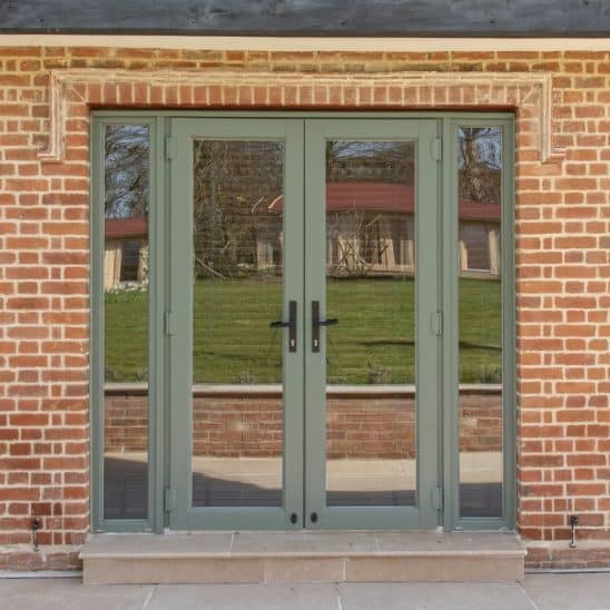 Evolution PVCu fully glazed French doors with side panels