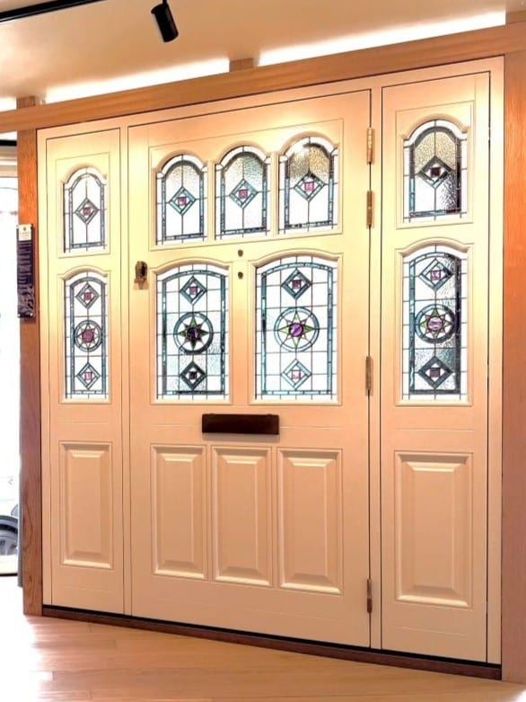 Bespoke Tenby & Penny stained glass on a large Timber door in our Norwich showroom on Farmers Avenue